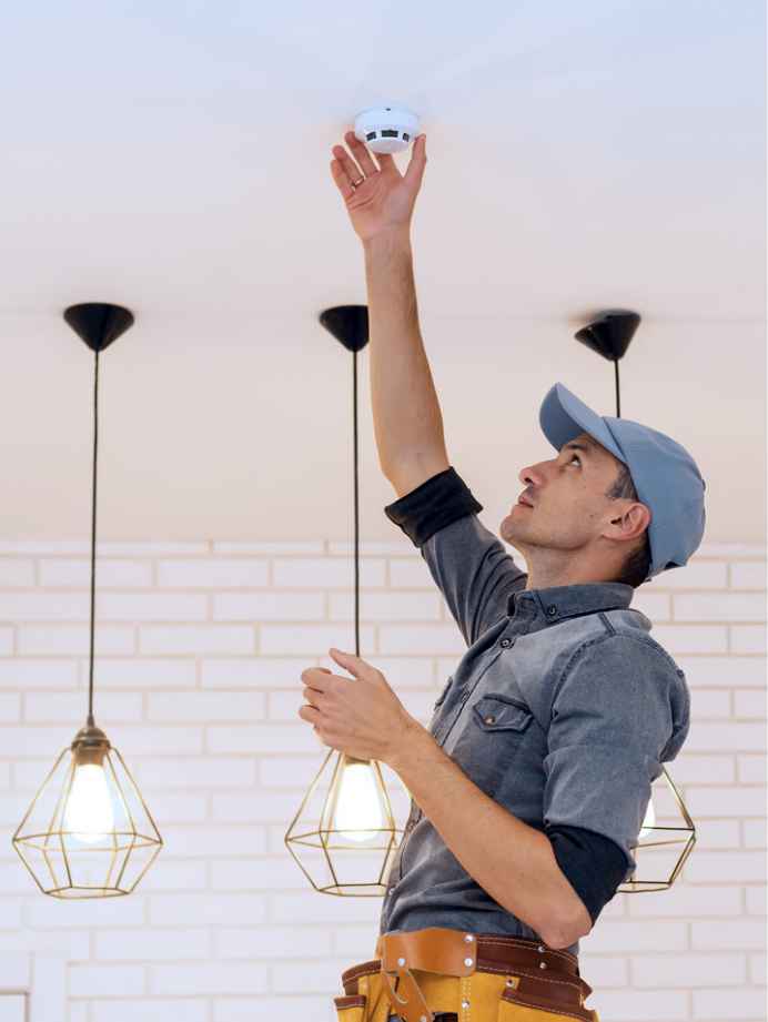 Man installing smoke detector